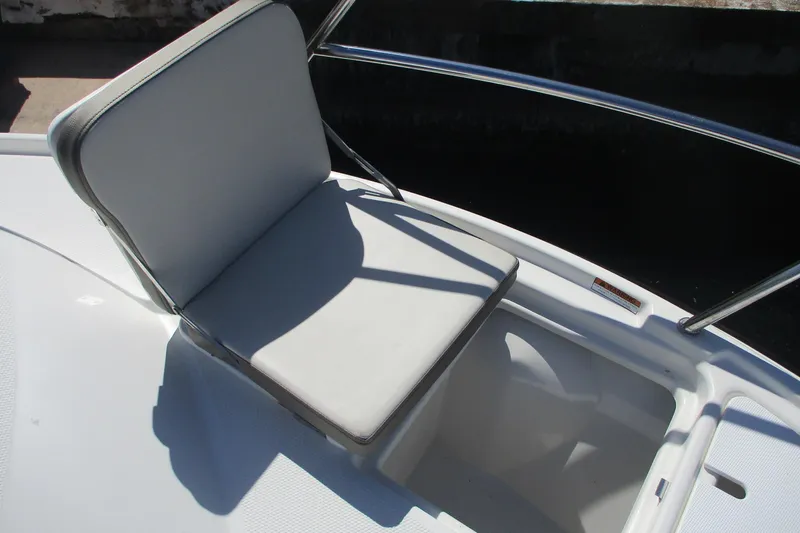 I'm Busy Yacht Photos Pics 2015 Cutwater 30 Command Bridge LE boat seat with white cushion and railing.