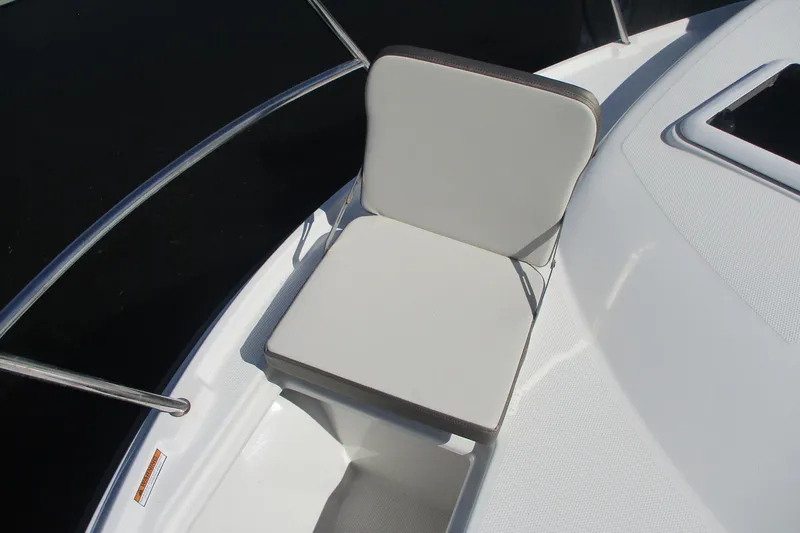 I'm Busy Yacht Photos Pics White cushioned seat on 2015 Cutwater 30 Command Bridge LE boat deck.