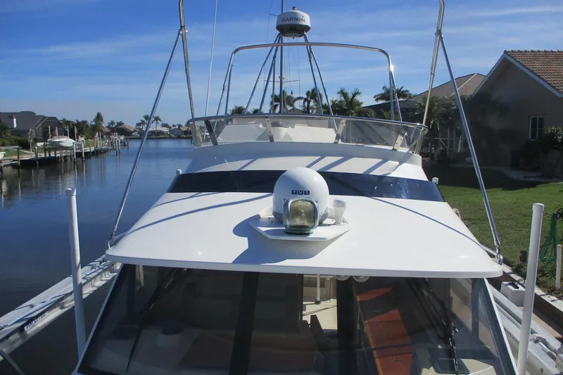 I'm Busy Yacht Photos Pics 2015 Cutwater 30 Command Bridge LE docked in a scenic canal setting.