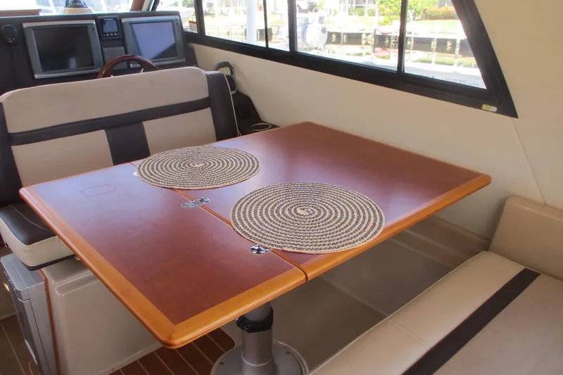 I'm Busy Yacht Photos Pics Interior of 2015 Cutwater 30 Command Bridge LE with dining table and seating.