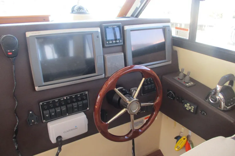 I'm Busy Yacht Photos Pics 2015 Cutwater 30 Command Bridge LE helm with dual screens and wooden steering wheel.