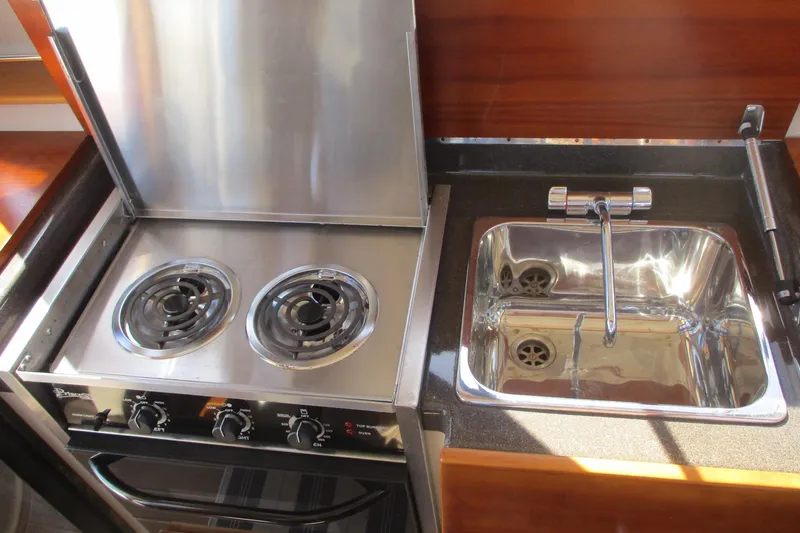 I'm Busy Yacht Photos Pics 2015 Cutwater 30 Command Bridge LE kitchen with stove and sink.
