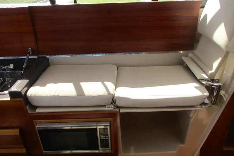 I'm Busy Yacht Photos Pics Interior of 2015 Cutwater 30 Command Bridge LE with cushioned seating and microwave.