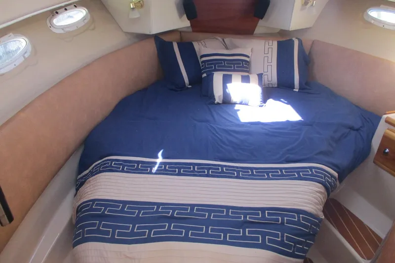 I'm Busy Yacht Photos Pics 2015 Cutwater 30 Command Bridge LE cabin with blue bedding and decorative pillows.