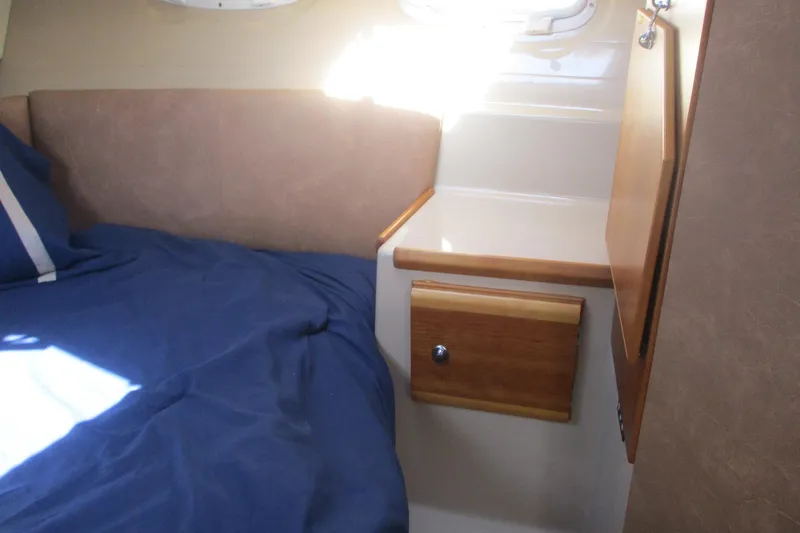 I'm Busy Yacht Photos Pics Interior cabin of 2015 Cutwater 30 Command Bridge LE with bed and storage.