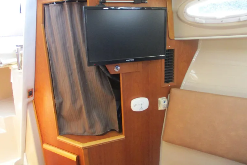 I'm Busy Yacht Photos Pics Interior of 2015 Cutwater 30 Command Bridge LE with TV and seating area.