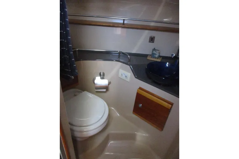 I'm Busy Yacht Photos Pics Compact bathroom in 2015 Cutwater 30 Command Bridge LE boat, featuring toilet and sink.