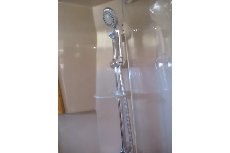 I'm Busy Yacht Photos Pics Shower area in 2015 Cutwater 30 Command Bridge LE boat, featuring chrome fixtures.