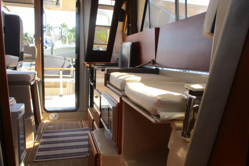 I'm Busy Yacht Photos Pics Interior of 2015 Cutwater 30 Command Bridge LE, featuring seating and cabinetry.