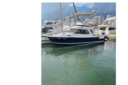 I'm Busy Yacht Photos Pics 2015 Cutwater 30 Command Bridge LE yacht docked in marina with cityscape background.