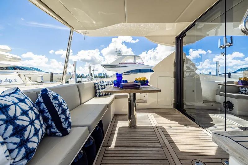 Sipsip Yacht Photos Pics Luxurious 2018 Absolute 52 FLY yacht deck with elegant seating and scenic ocean view.
