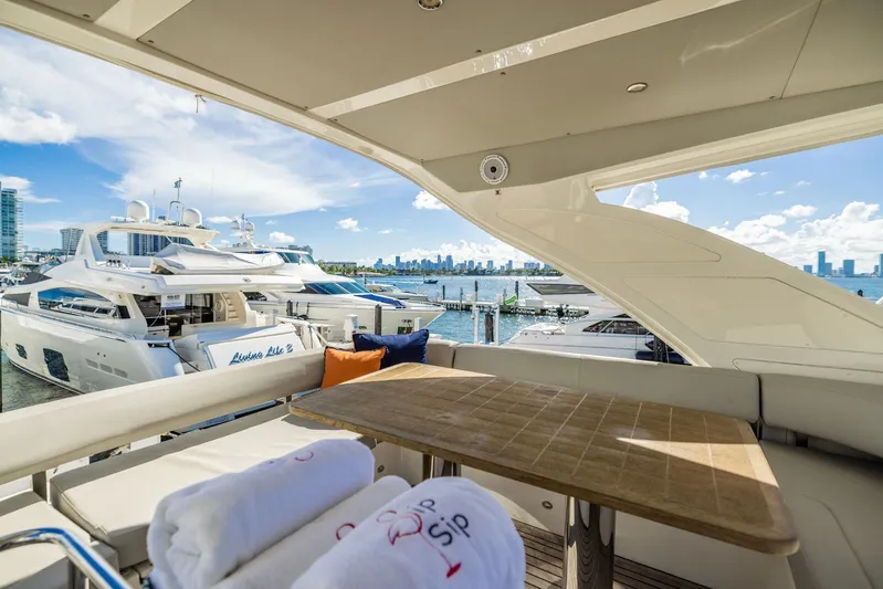 Sipsip Yacht Photos Pics Luxurious 2018 Absolute 52 FLY yacht with elegant seating and scenic marina view.