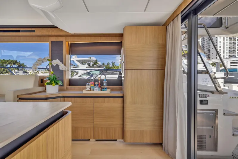 Sipsip Yacht Photos Pics Luxurious interior of 2018 Absolute 52 FLY yacht with modern wood cabinetry and scenic window view.