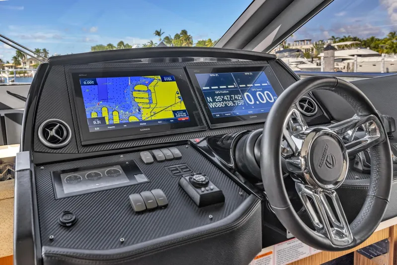 Sipsip Yacht Photos Pics Cockpit of 2018 Absolute 52 FLY yacht with navigation screens and steering wheel.