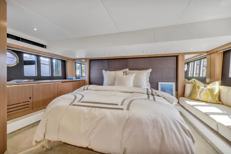 Sipsip Yacht Photos Pics Luxurious bedroom interior on a 2018 Absolute 52 FLY yacht, featuring elegant bedding and modern design.
