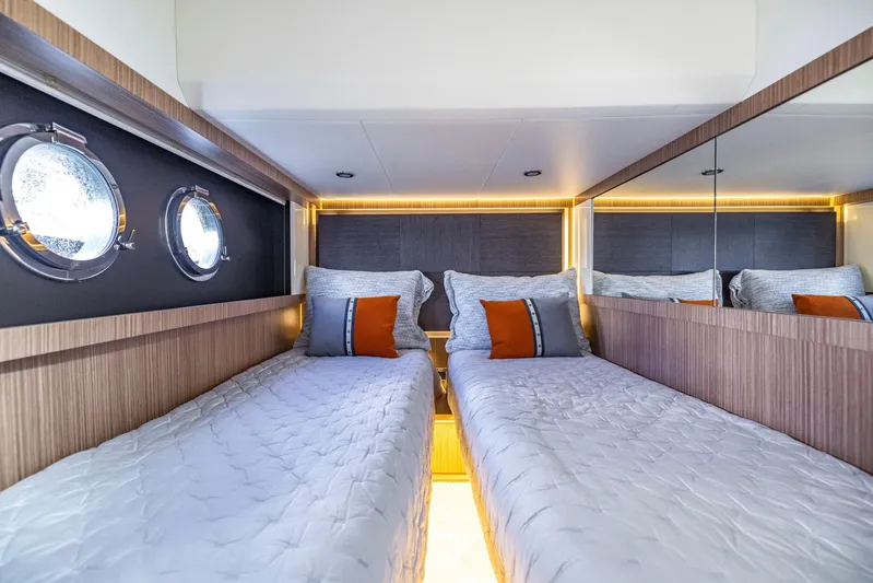 Sipsip Yacht Photos Pics Luxurious twin cabin in 2018 Absolute 52 FLY yacht with modern decor and porthole windows.