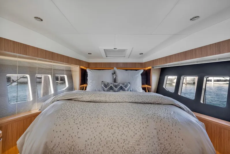 Sipsip Yacht Photos Pics Luxurious bedroom interior of 2018 Absolute 52 FLY yacht with elegant bedding and panoramic windows.