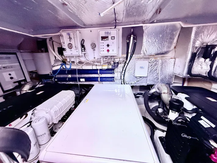 Sipsip Yacht Photos Pics Engine room of a 2018 Absolute 52 FLY yacht, featuring advanced mechanical systems.