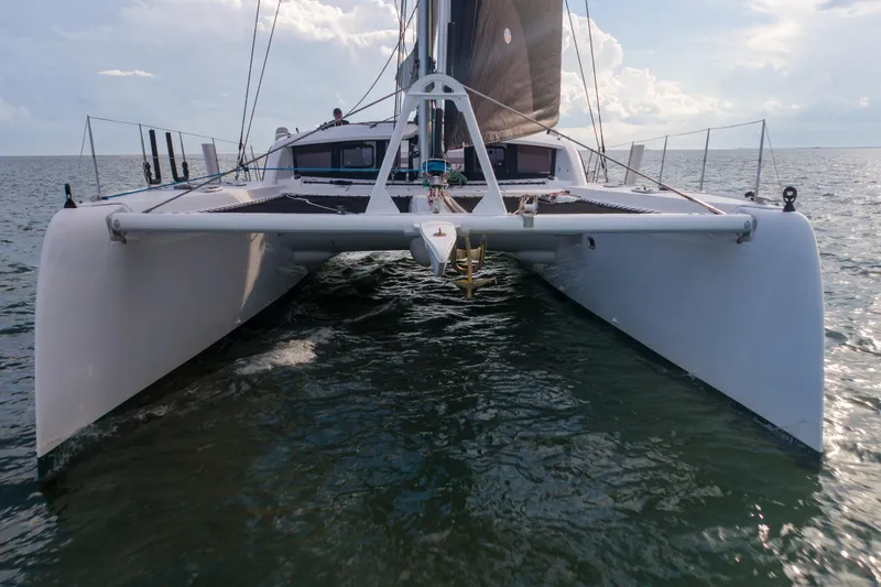 Rima Yacht Photos Pics 2018 Outremer 51 catamaran sailing on open water, front view.