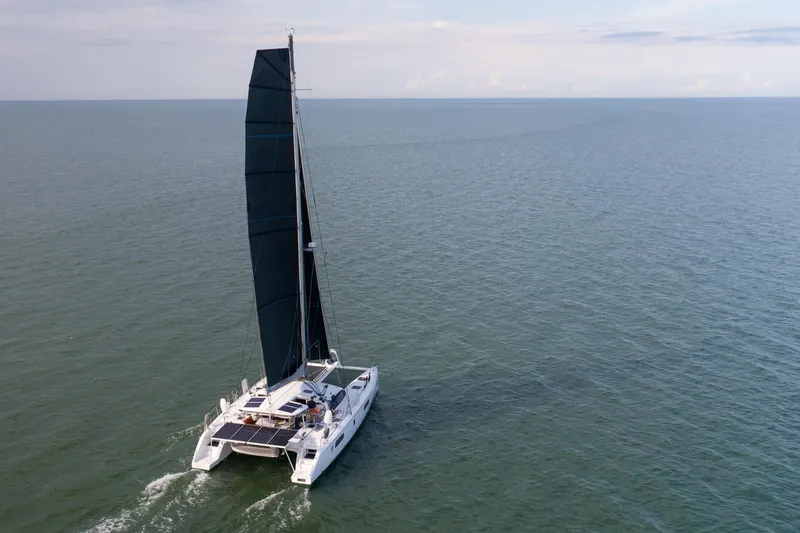 Rima Yacht Photos Pics 2018 Outremer 51 catamaran sailing on open sea under clear skies.