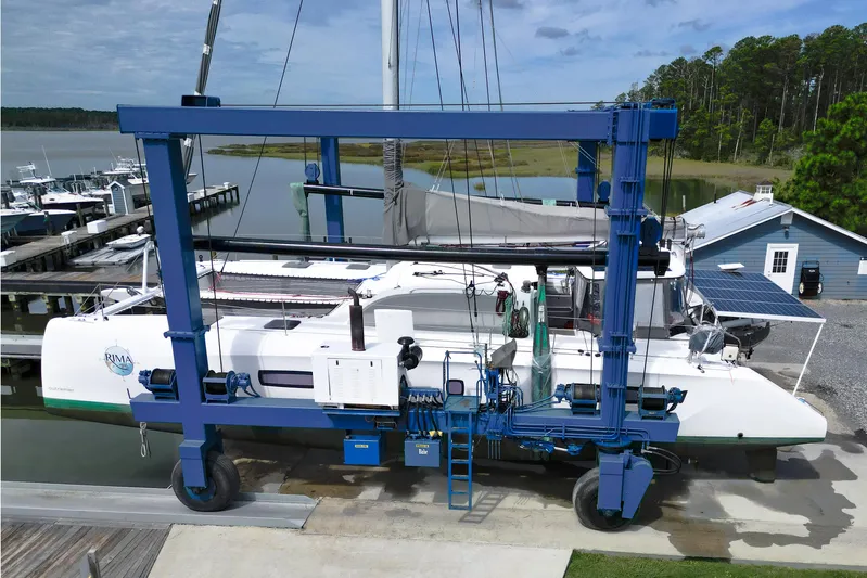 Rima Yacht Photos Pics 2018 Outremer 51 catamaran in dry dock, surrounded by marina and greenery.