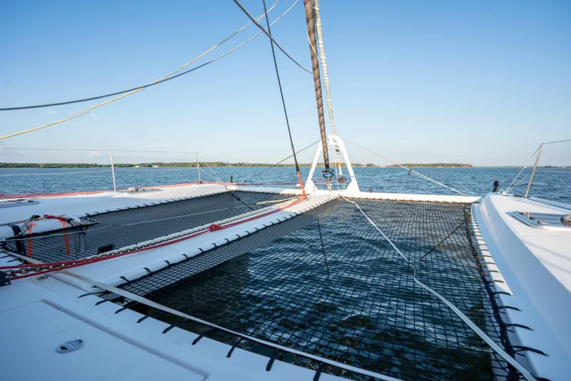 Rima Yacht Photos Pics 2018 Outremer 51 catamaran sailing on calm waters under clear blue skies.