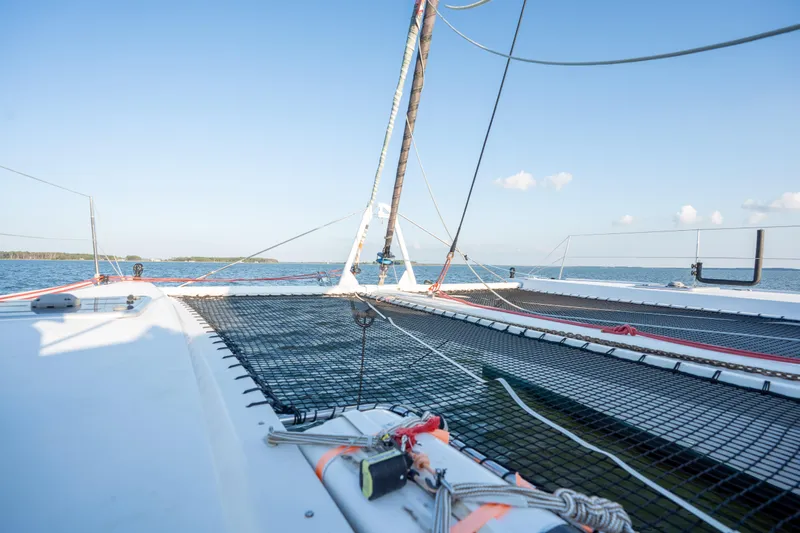 Rima Yacht Photos Pics 2018 Outremer 51 catamaran deck view with netting, sailing on calm blue waters.