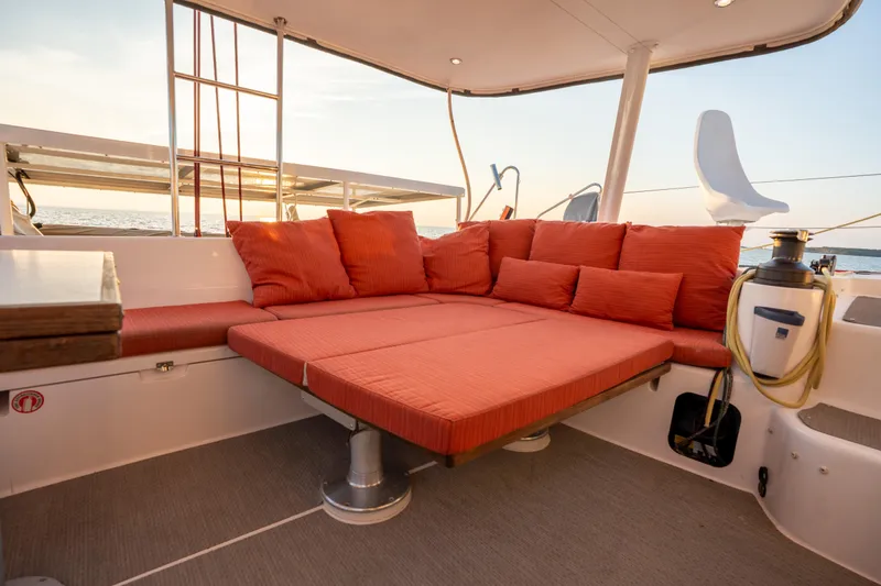Rima Yacht Photos Pics Luxurious 2018 Outremer 51 yacht with spacious orange seating area at sunset.