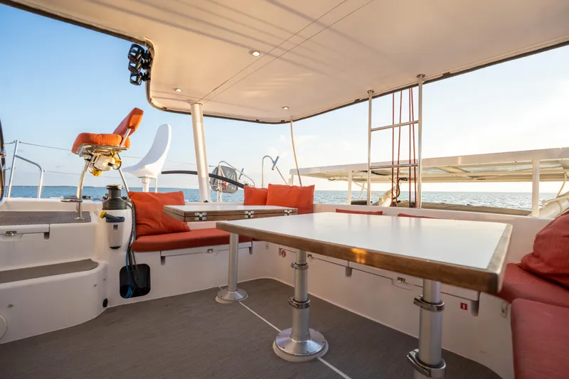 Rima Yacht Photos Pics Spacious deck of 2018 Outremer 51 catamaran with seating and table, ocean view.