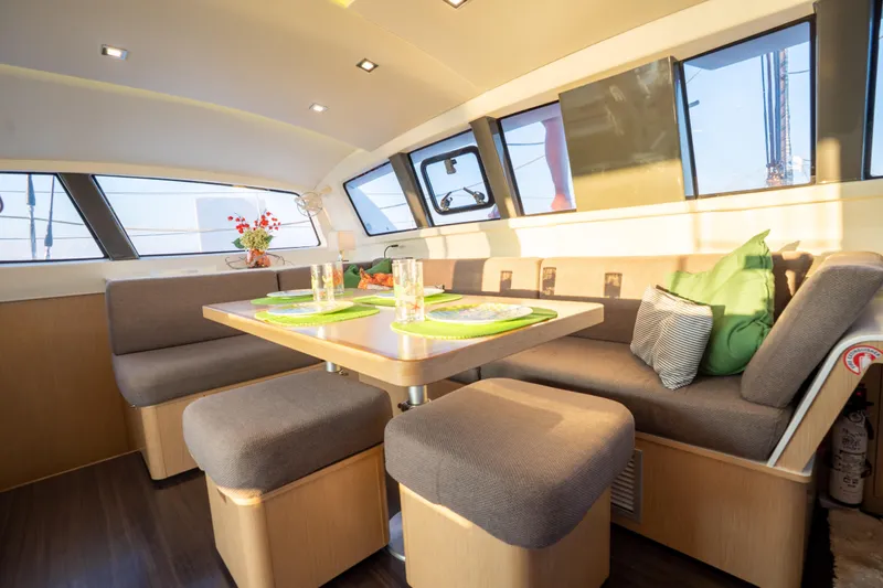 Rima Yacht Photos Pics Luxurious interior of 2018 Outremer 51 catamaran with cozy seating and dining area.