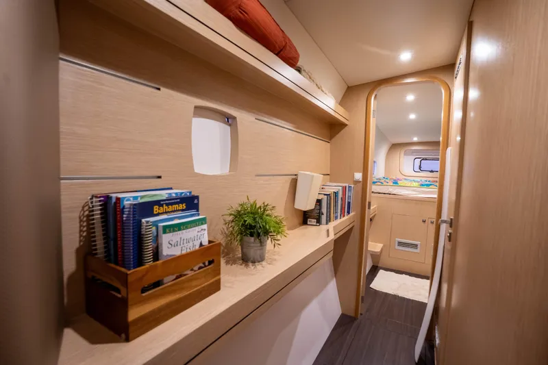 Rima Yacht Photos Pics Interior of 2018 Outremer 51 yacht with books, plants, and cozy cabin.