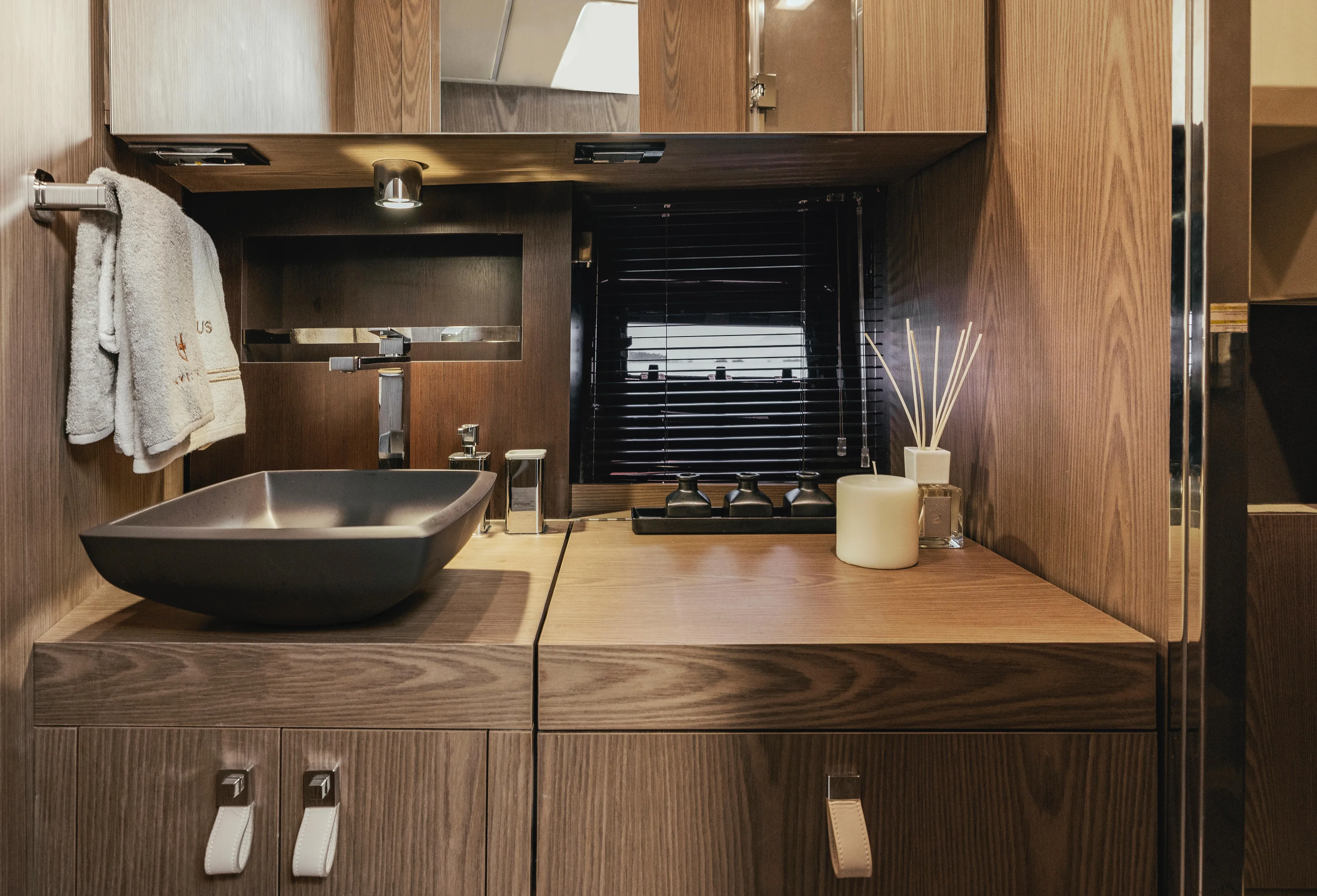 Yacht Photos Pics Luxurious bathroom interior of 2025 Invictus TT420 yacht with modern sink and wooden cabinetry.