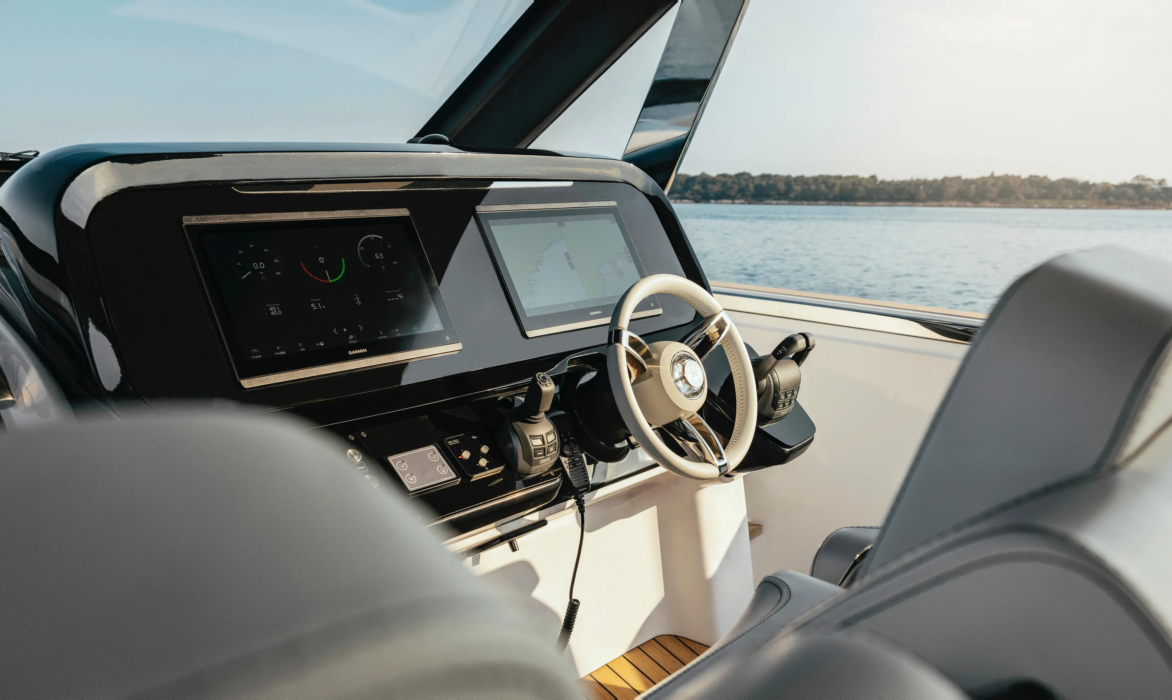  Yacht Photos Pics Helm of 2025 Invictus TT420 yacht with modern controls and scenic water view.
