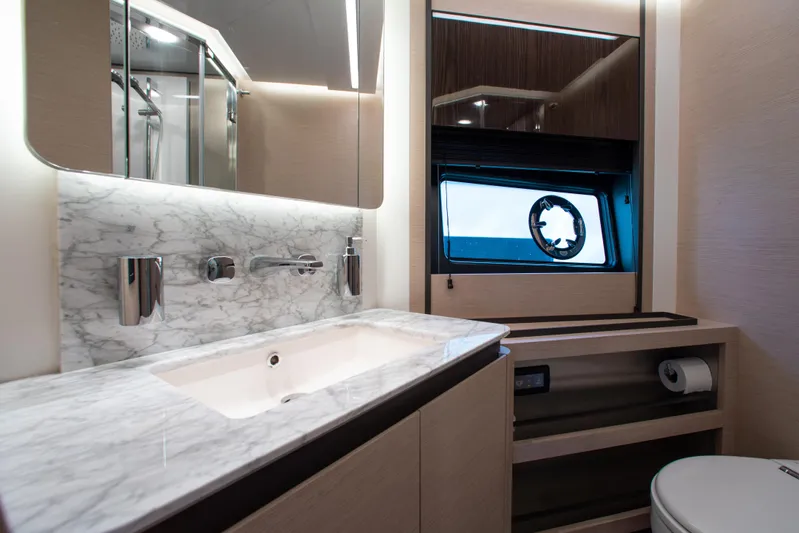  Yacht Photos Pics Luxurious bathroom in 2022 Azimut S8 yacht with marble countertop and modern fixtures.