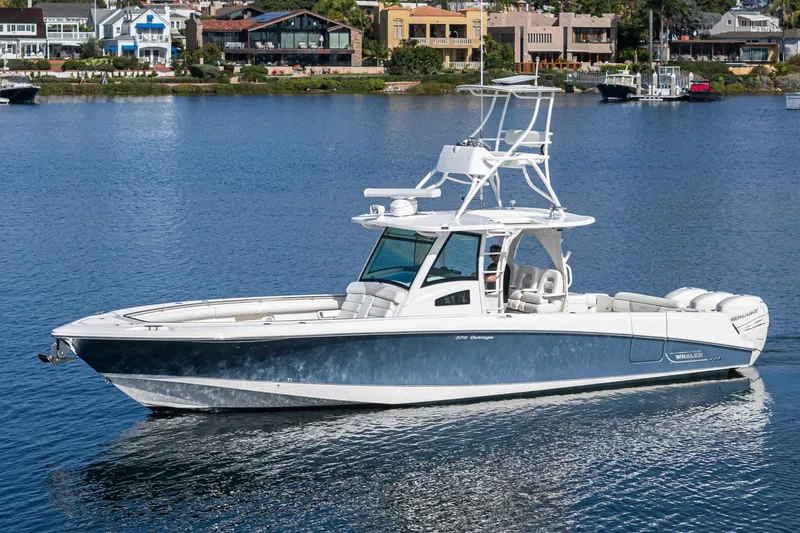 Vaquero Chingon Yacht Photos Pics 2016 Boston Whaler 370 Outrage boat on calm water near waterfront homes.