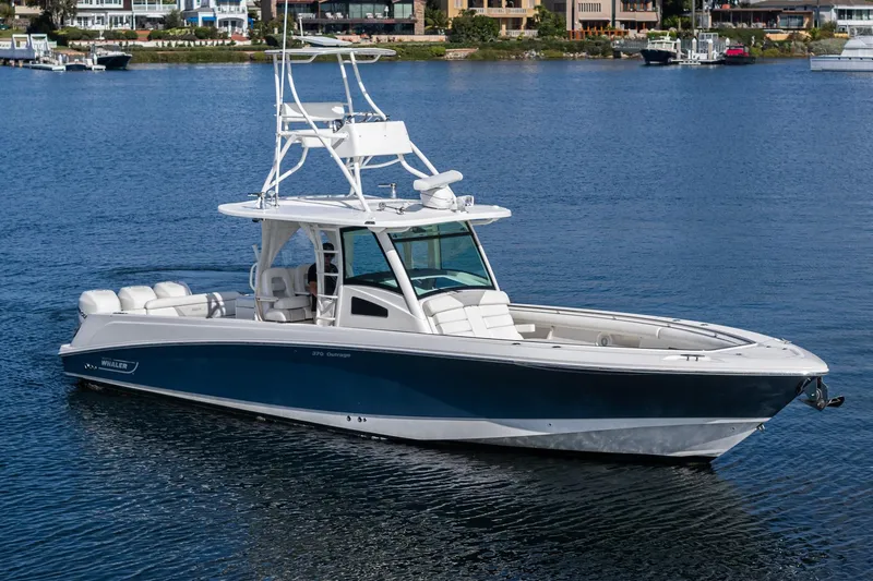 Vaquero Chingon Yacht Photos Pics 2016 Boston Whaler 370 Outrage boat on calm water, showcasing sleek design and luxury features.