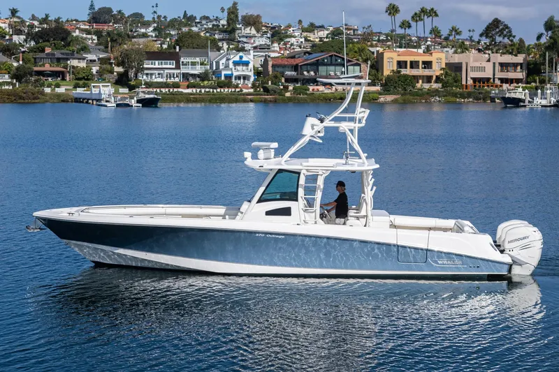 Vaquero Chingon Yacht Photos Pics 2016 Boston Whaler 370 Outrage boat cruising on a scenic waterfront.