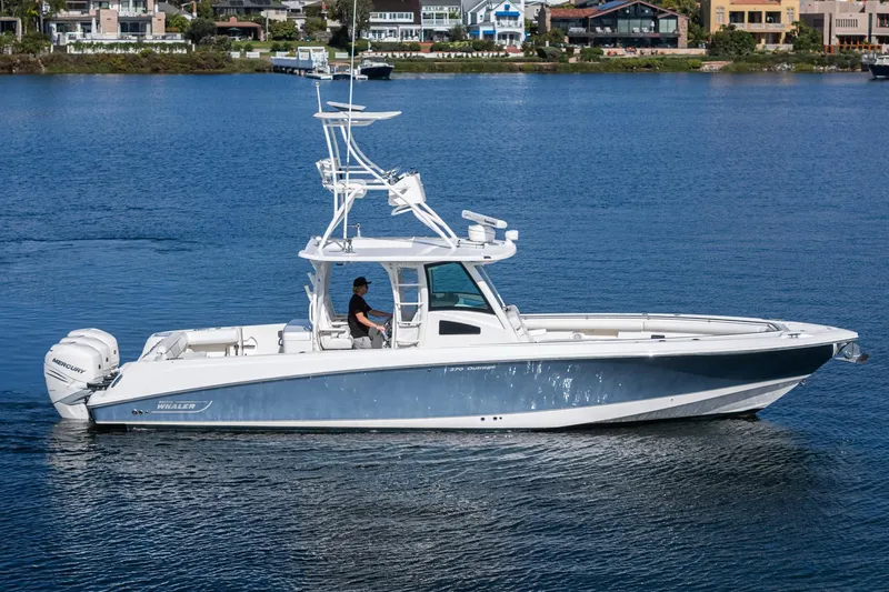 Vaquero Chingon Yacht Photos Pics 2016 Boston Whaler 370 Outrage boat cruising on a calm lake.