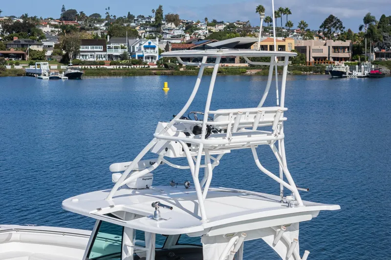 Vaquero Chingon Yacht Photos Pics Boston Whaler 370 Outrage 2016 boat with elevated helm, docked near scenic waterfront homes.