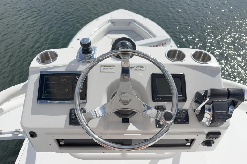 Vaquero Chingon Yacht Photos Pics 2016 Boston Whaler 370 Outrage helm with steering wheel and navigation controls.