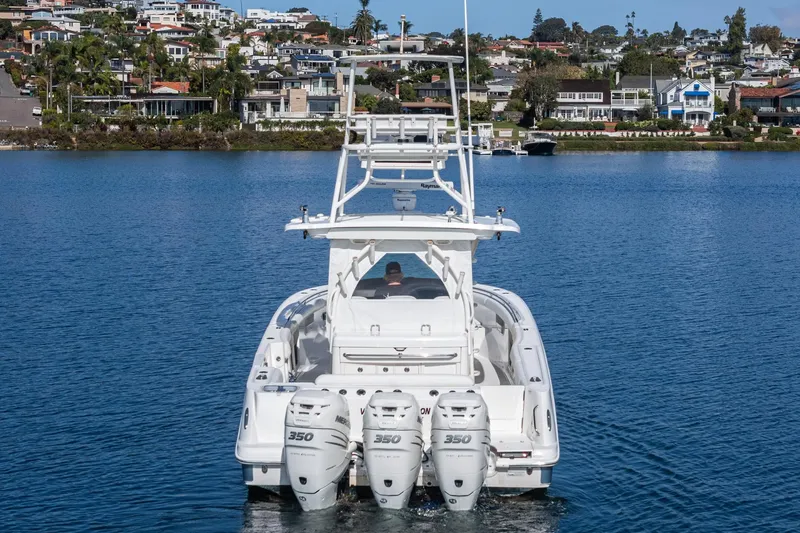 Vaquero Chingon Yacht Photos Pics 2016 Boston Whaler 370 Outrage with triple 350 engines on a calm lake.