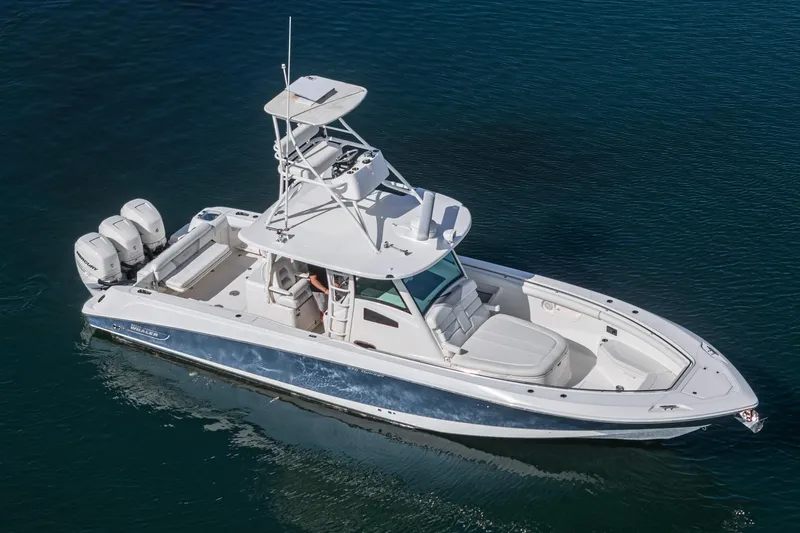 Vaquero Chingon Yacht Photos Pics 2016 Boston Whaler 370 Outrage boat on calm water, featuring triple outboard engines.