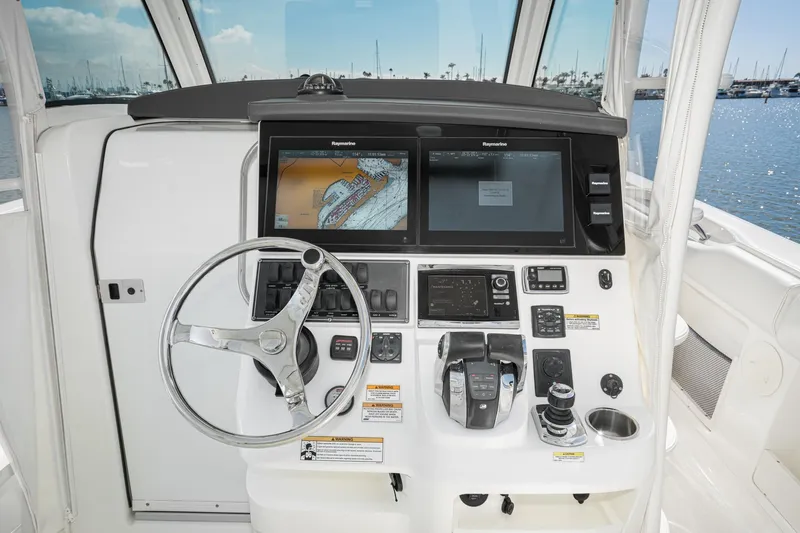 Vaquero Chingon Yacht Photos Pics Helm of 2016 Boston Whaler 370 Outrage with navigation screens and controls.