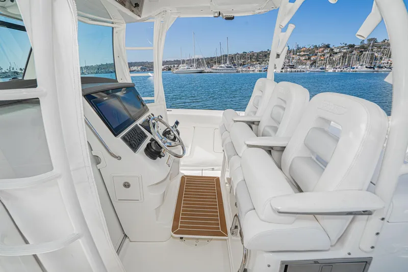 Vaquero Chingon Yacht Photos Pics 2016 Boston Whaler 370 Outrage helm with white seating and ocean view.