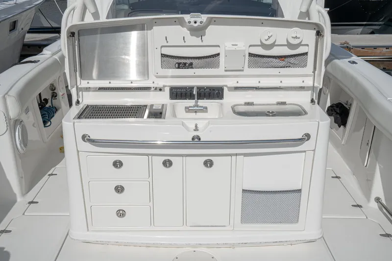 Vaquero Chingon Yacht Photos Pics 2016 Boston Whaler 370 Outrage boat galley with sink, grill, and storage compartments.