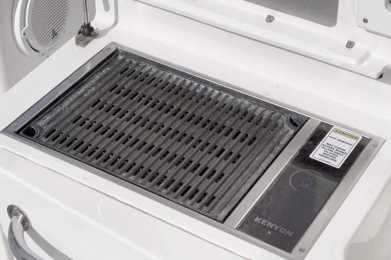 Vaquero Chingon Yacht Photos Pics Kenyon grill on 2016 Boston Whaler 370 Outrage boat, featuring a sleek design.