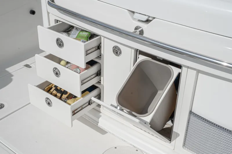 Vaquero Chingon Yacht Photos Pics 2016 Boston Whaler 370 Outrage storage drawers and trash compartment detail.