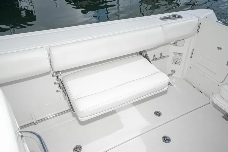 Vaquero Chingon Yacht Photos Pics 2016 Boston Whaler 370 Outrage boat with white cushioned seating and cup holder.