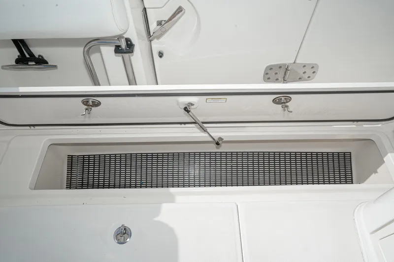 Vaquero Chingon Yacht Photos Pics 2016 Boston Whaler 370 Outrage storage compartment with open hatch and metal hinges.
