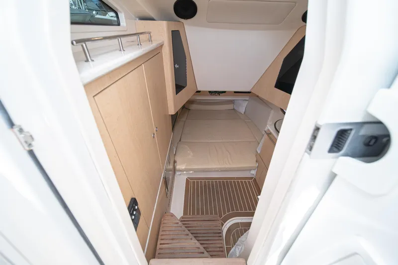 Vaquero Chingon Yacht Photos Pics 2016 Boston Whaler 370 Outrage cabin interior with bed and wooden cabinetry.